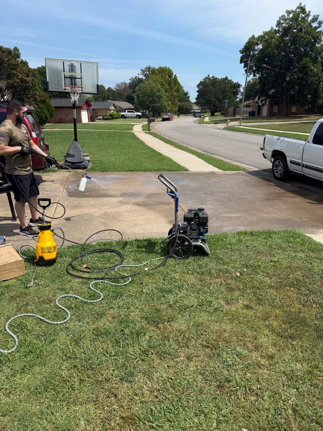 Foam cannon and detergent on a driveway during a pressure washing job