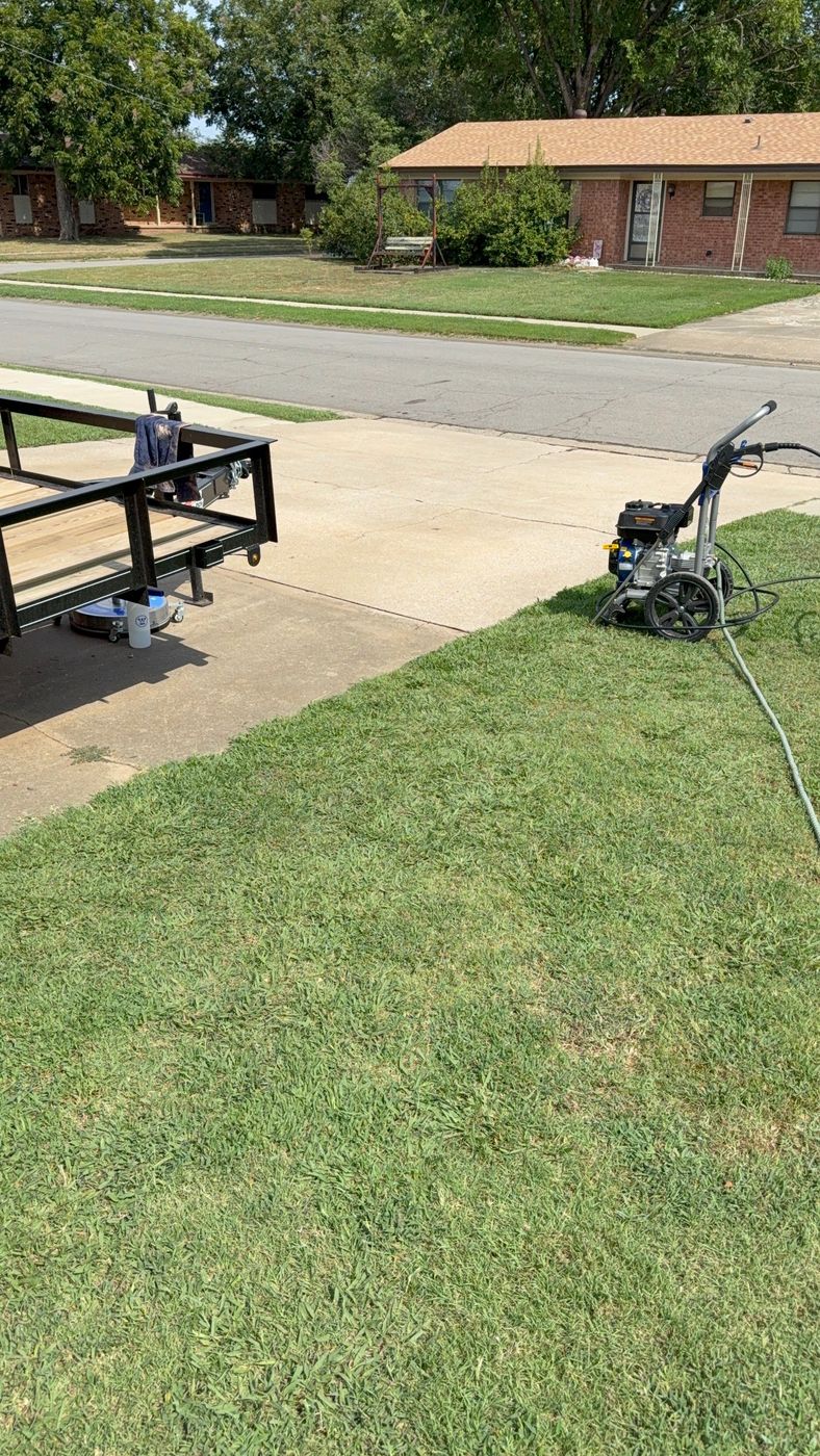 Pressure washer and trailer set up on a residential driveway